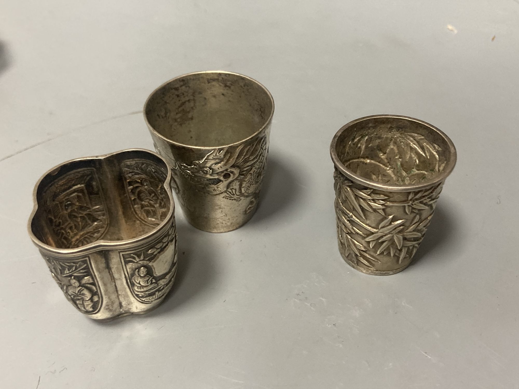 Two Chinese white metal tots, one by Wang Hing and seven other Chinese items including white metal napkin ring etc.